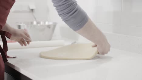 An-early-stage-of-rolling-out-the-dough-for-butter-cookies-in-an-artisan-pastry-shop,-4K