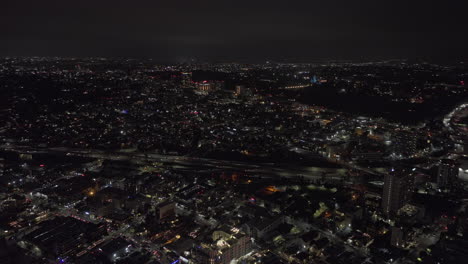 San-Diego-California-Aerial-v113-drone-flyover-little-italy-capturing-night-downtown-cityscape,-traffic-on-freeway-and-airplane-landing-at-the-airport---Shot-with-Mavic-3-Cine---September-2022
