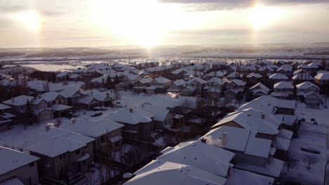 Sun-dogs-optical-illusion-over-winter-snowy-community-while-flying-drone