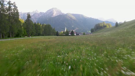 Flying-very-close-the-field-near-the-church-in-a-small-alpine-village-in-the-Dolomites