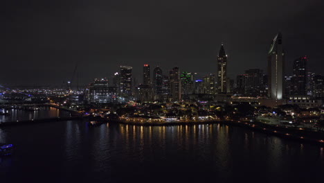San-Diego-California-Aerial-v105-low-flyover-bay-across-embarcadero-marina-capturing-seaport-village-waterfront-shopping-district-and-downtown-night-cityscape---Shot-with-Mavic-3-Cine---September-2022