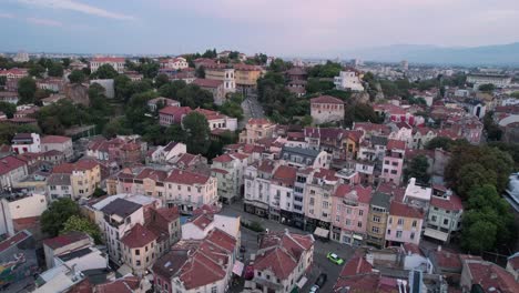 Aerial-drone-flying-above-typical-colorful-Bulgarian-houses-in-Plovdiv,-forward