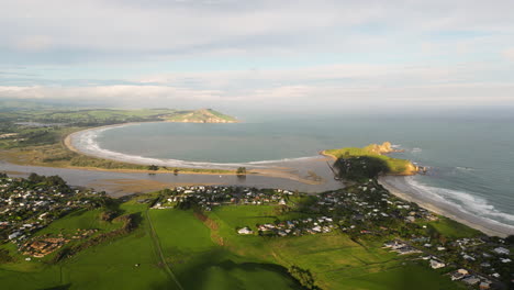 Coast-of-Karitane-town-and-Huriawa-peninsula,-South-Island,-New-Zealand,-aerial-view