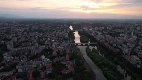 Establisher-aerial-view-of-Plovdiv-old-town-with-river-and-bridges-at-sunset