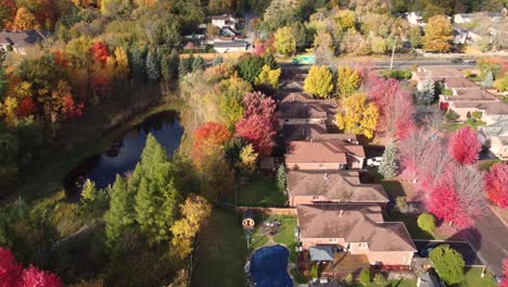 Aerial-shot-of-residential-homes-in-wooded-area-during-autumn