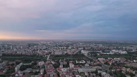 Stunning-establisher-aerial-drone-shot-of-city-of-Plovdiv,-flying-above-rooftops