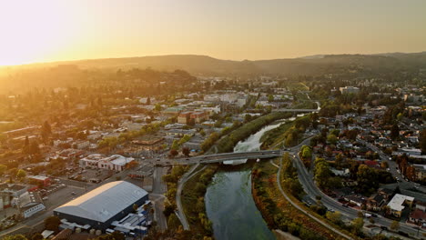 Santa-Cruz-California-Aerial-v13-flyover-above-san-lorenzo-river-with-sunset-shinning-across-town,-pan-right-on-soquel-avenue-bridge-capturing-charming-neighborhood---Shot-with-Mavic-3-Cine---May-2022