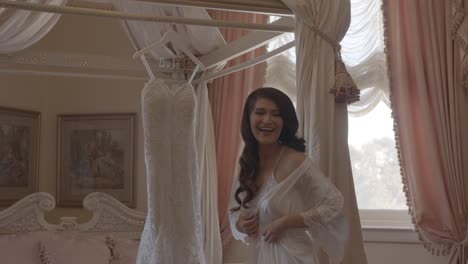 Bride-getting-ready-to-try-on-wedding-dress