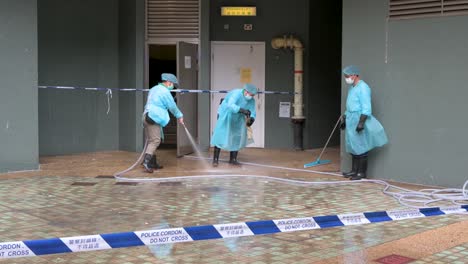 Health-workers-disinfect-the-street-outside-a-building-placed-under-lockdown-after-a-large-number-of-residents-tested-positive-in-Hong-Kong