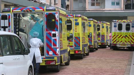 Ambulances-and-health-workers-prepare-for-a-mass-number-of-Covid-19-Coronavirus-positive-cases-outside-a-building-placed-under-lockdown-at-a-public-housing-complex-in-Hong-Kong