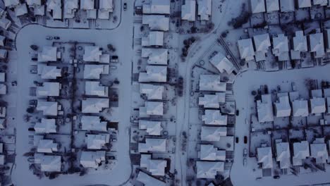 Top-down-drone-shot-of-the-houses-covered-with-snow-in-sunset-in-Calgary-in-winter-time