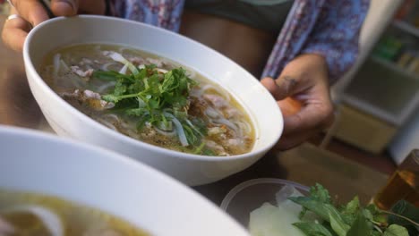 Gorgeous-woman-in-bikini-eating-vietnamese-traditional-pho-beef-noodle-soup-in-local-restaurant