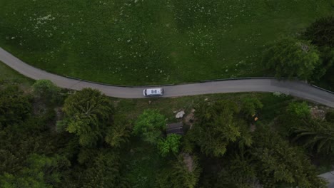 aerial-view-of-car-driving-on-winding-road-in-Passo-Gardena,-Dolomites