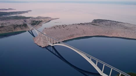 Krk-Bridge-between-island-and-mainland-Croatia-at-sunrise,-aerial