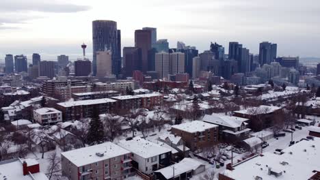 Aerial-shot-of-the-Calgary-Downtown-in-winter-time-and-houses-covered-with-snow