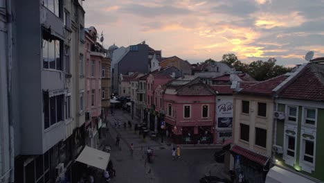 Aerial-drone-of-streets-of-Plovdiv-Old-town,-Bulgaria,-rise-reveal-Djumaya-Mosque-tower