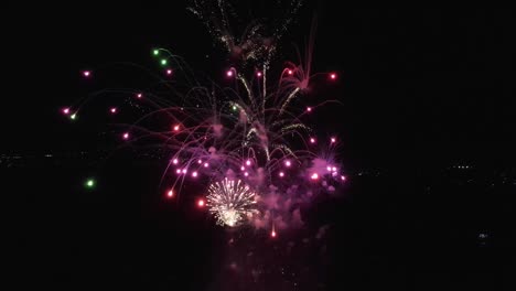 drone-flying-over-multicolored-explosions-of-fireworks-in-the-air