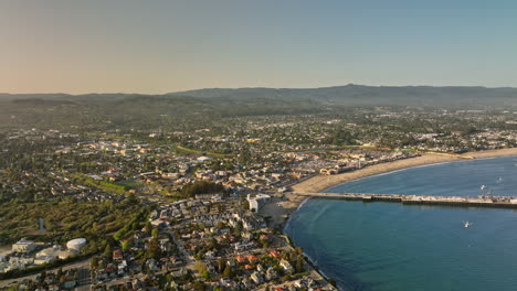 Santa-Cruz-California-Aerial-v5-flyover-lighthouse-neighborhood-capturing-charming-townscape,-popular-recreational-municipal-wharf-pier-and-seaside-amusement-park---Shot-with-Mavic-3-Cine---May-2022