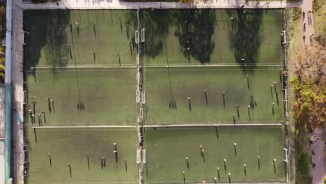 Aerial-straight-down-shot-of-many-soccer-fields-during-training-session-in-summer