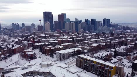 Flying-towards-Calgary-Downtown-over-houses-covered-with-snow