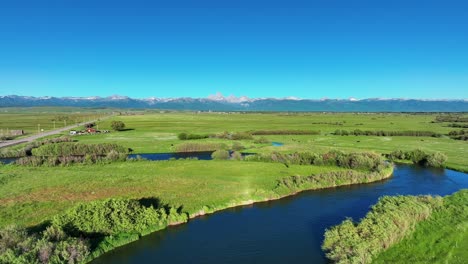 Scenic-Green-Fields-And-River-In-Saint-Anthony,-Idaho,-United-States---aerial-drone-shot