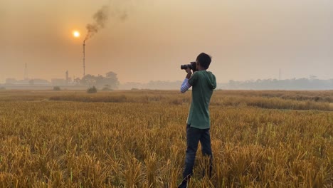 Cinematic-view-of-photographer-taking-pictures-of-polluting-industrial-area