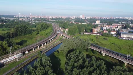 Railway-intersection-with-skyline-of-Milan-city,-aerial-view