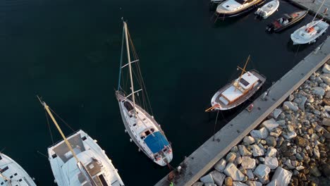 Stunning-shot-of-a-sailing-yacht-docked-in-the-beautiful-island-of-Paros,-Greece-during-summer