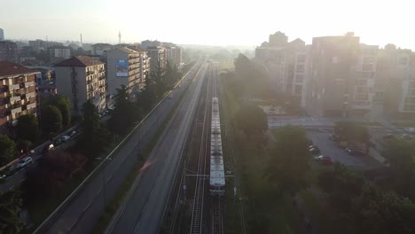 Milano-subway-transportation-in-living-district,-aerial-drone-view-on-sunny-evening