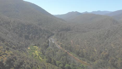 Aerial-shot-moving-forward-and-revealing-a-high-country-river-flowing-through-the-Australian-bush