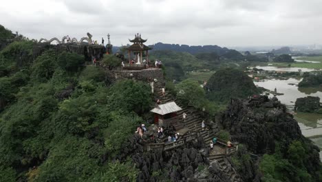 People-climbing-stairs-on-the-side-of-a-mountain-to-reach-a-temple-in-the-sky
