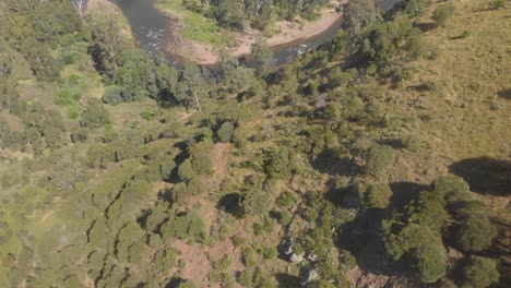 Aerial-shot-revealing-a-vally-and-river-flowing-through-in-Australias-high-country