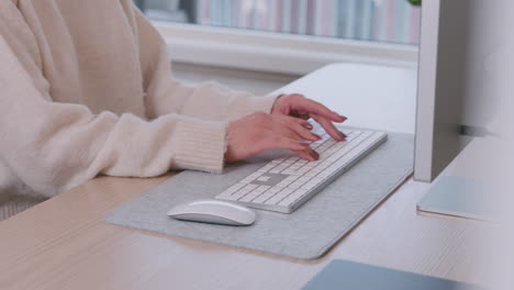 Hands-Of-A-Female-Freelancer-At-Home-Typing-On-Wireless-Computer-Keyboard-On-The-Table