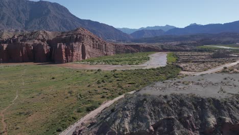 Aerial-View-Above-Calchaqui-Valleys-in-Quebrada-de-Cafayate,-Vineyard-Route,-Mountain-Range-Scenic-Formation-into-Subtropical-Landscape,-Salta,-Argentina-Travel-and-Tourism