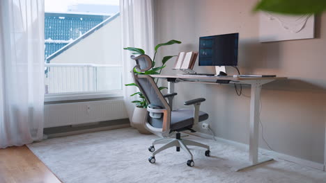 Home-Office-Desk-And-Chair-With-Desktop-Computer-Near-The-Open-Window