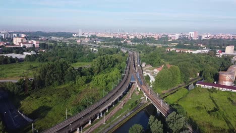 Railway-entering-city-of-Milan,-aerial-drone-view