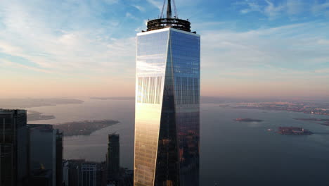 Aerial-view-away-from-the-WTC-tower-with-Upper-bay-in-the-background,-in-New-York---pull-back,-drone-shot