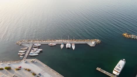 Beautiful-aerial-footage-of-boats-and-sailing-yachts-docked-in-the-picturesque-Naoussa-Marina-of-Paros,-Greece