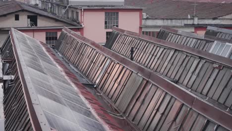 Vintage-rooftops-windows-of-old-factory-in-Milan,-handheld-view