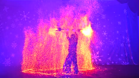 Flaming-Showmanship:-Male-Fire-Performers-Impress-with-Rolling-and-Spinning-Fire-Torch-Tricks-at-the-Mittelalterlicher-Lichter-Weihnachtsmarkt-Dortmund