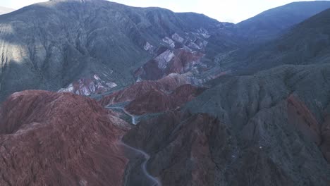 Aerial-Drone-Fly-Above-Purmamarca,-Jujuy,-Seven-Color-Hills,-Geological-Mountain-Range-Route-in-Argentina,-Natural-South-America