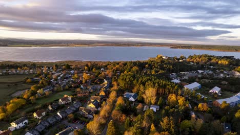 Aerial-drone-flight-over-Findhorn-Bay-ecovillage-in-picturesque-landscapes-the-Scottish-mountains-and-sea,-natural-beauty-of-the-island