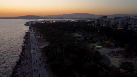 An-impressive-low-altitude-aerial-drone-shot-of-the-entire-Floisvos-area-in-Athens-during-sunset