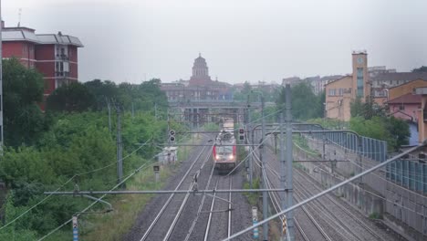 Front-view-of-cargo-train-passing-by-in-Milan-suburbs
