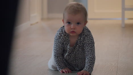 Baby-crawling-on-floor-at-home,-mother-running-forward