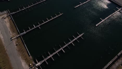 An-aerial-view-over-an-empty-marina-in-Freeport,-NY-on-a-sunny-day