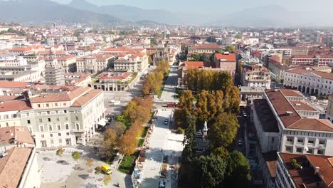 Bergamo-city-downtown-and-horizon,-aerial-drone-fly-backward-view