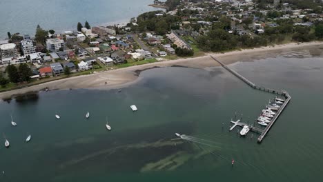 Aerial-shot-of-Soldiers-Point-with-its-Beach-and-own-Boat-Jetty-NSW-Australia