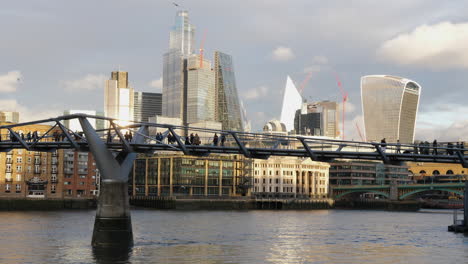 Slomo-static-shot-of-unrecognizable-people-walking-on-London-Millennium-Bridge