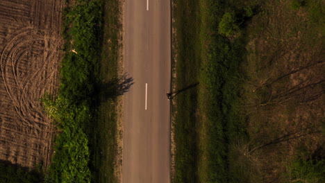 Tracking-Drone-shot-of-Woman-running-top-down-view